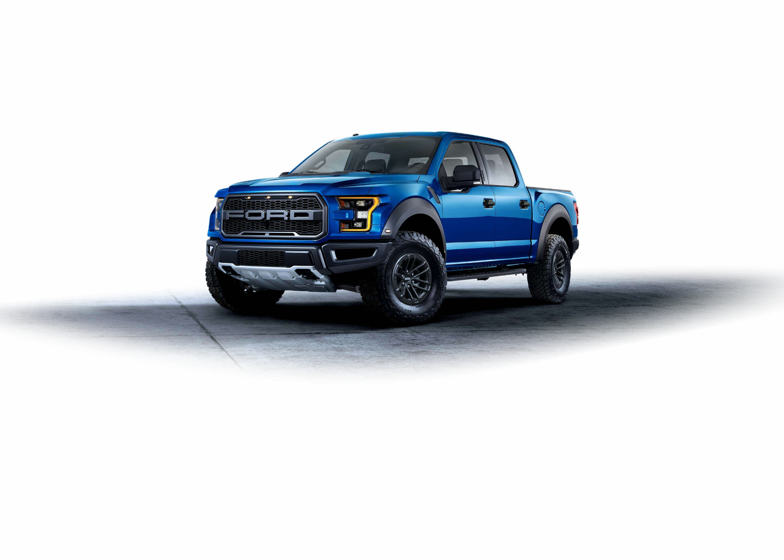 Blue 2020 Ford F-150 Raptor in a front three-quarter view on a studio floor.